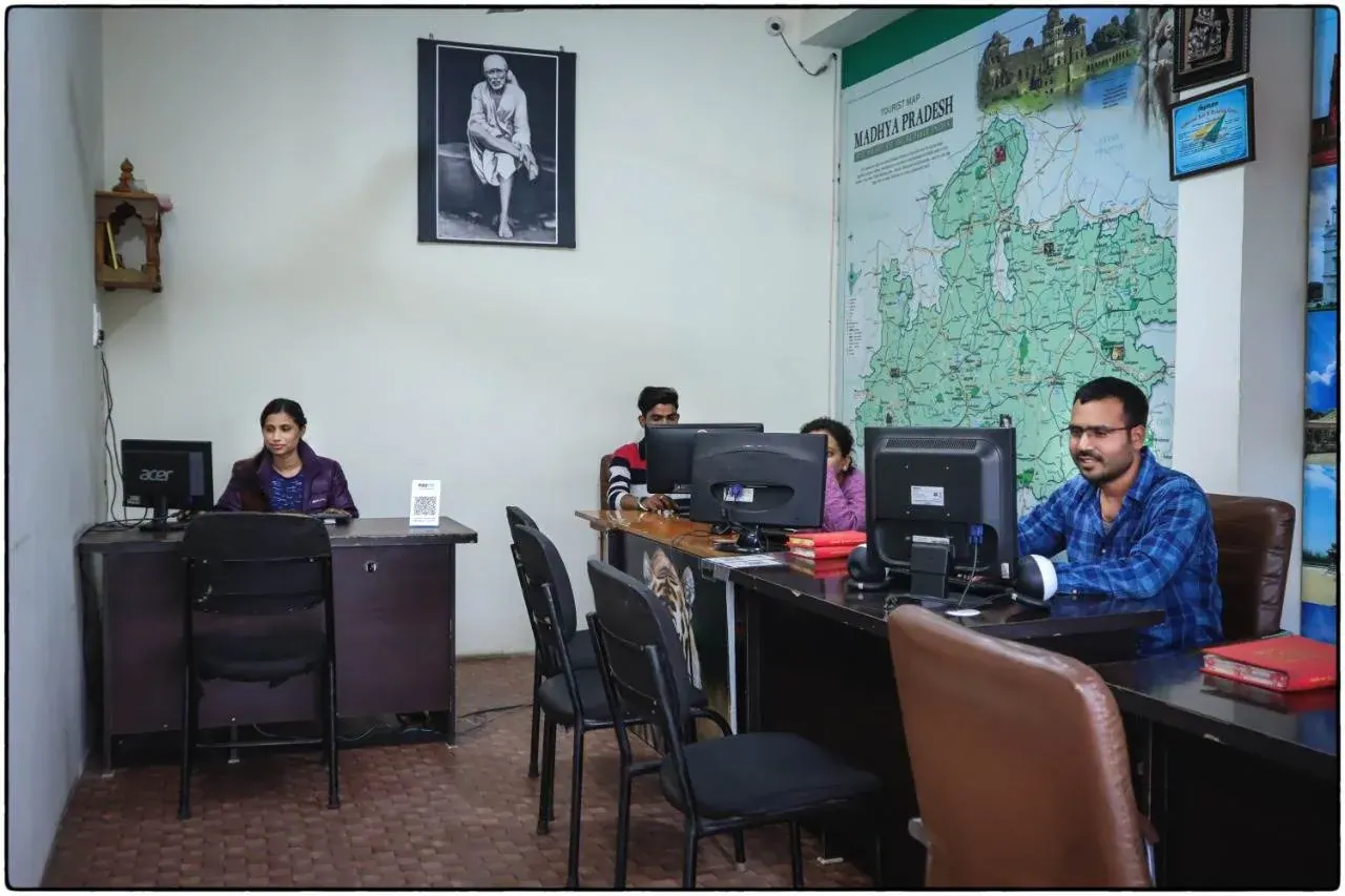 Banjari MP Tours team at the Jabalpur office, with the Madhya Pradesh map on the wall